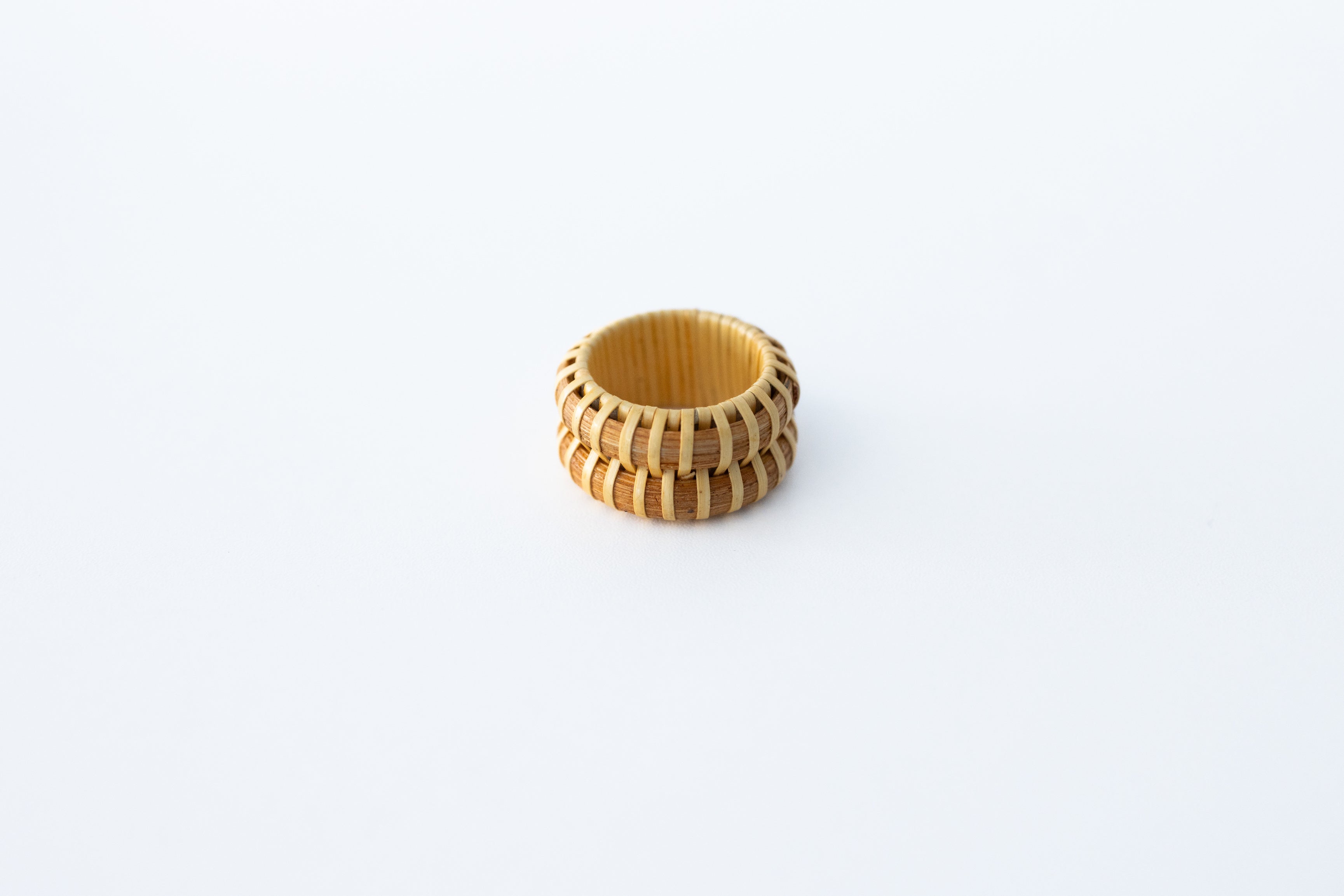 A beige double stave Nantucket basket ring on a white background.
