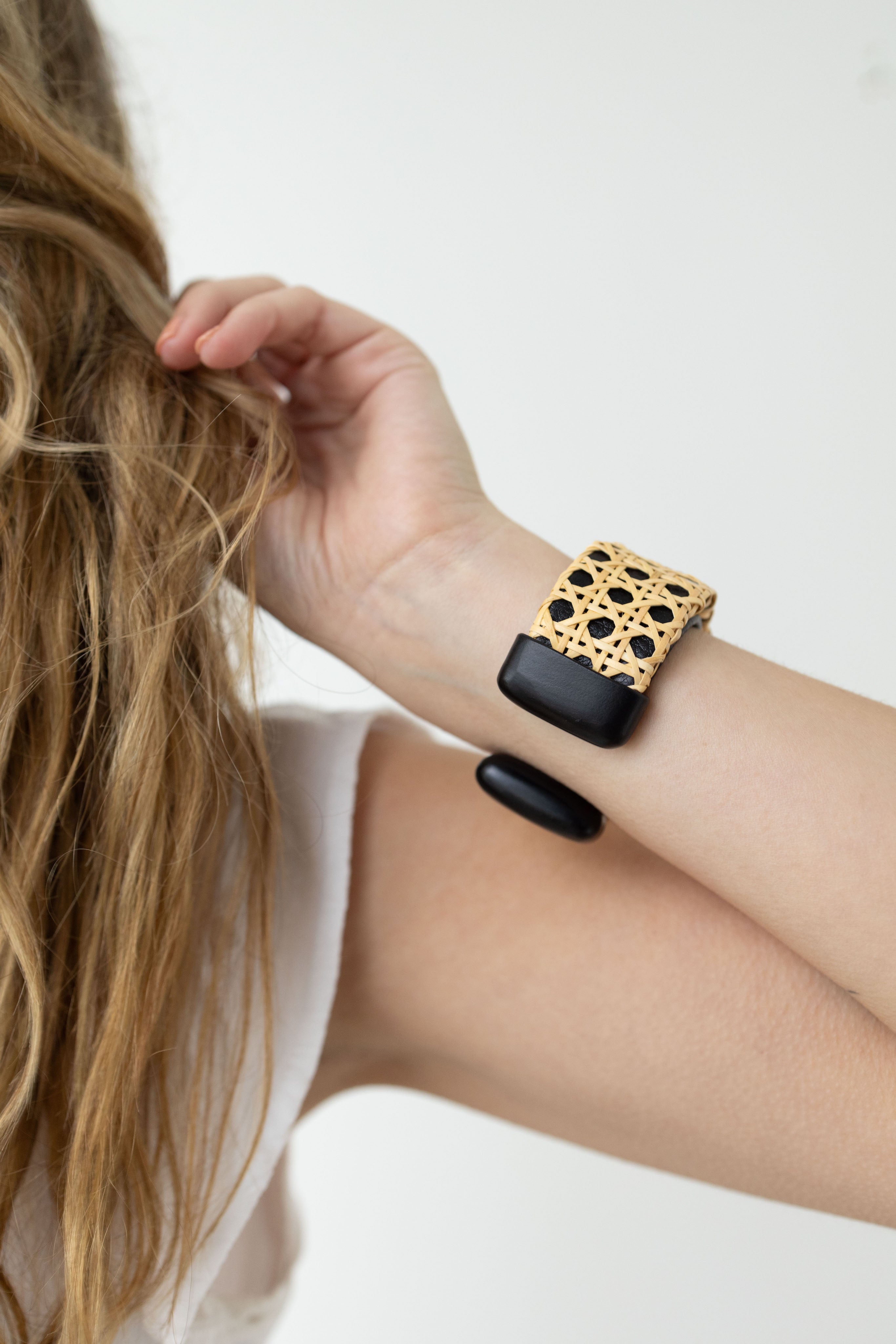 Close up on the back of the black bracelet cuff around woman's wrist.