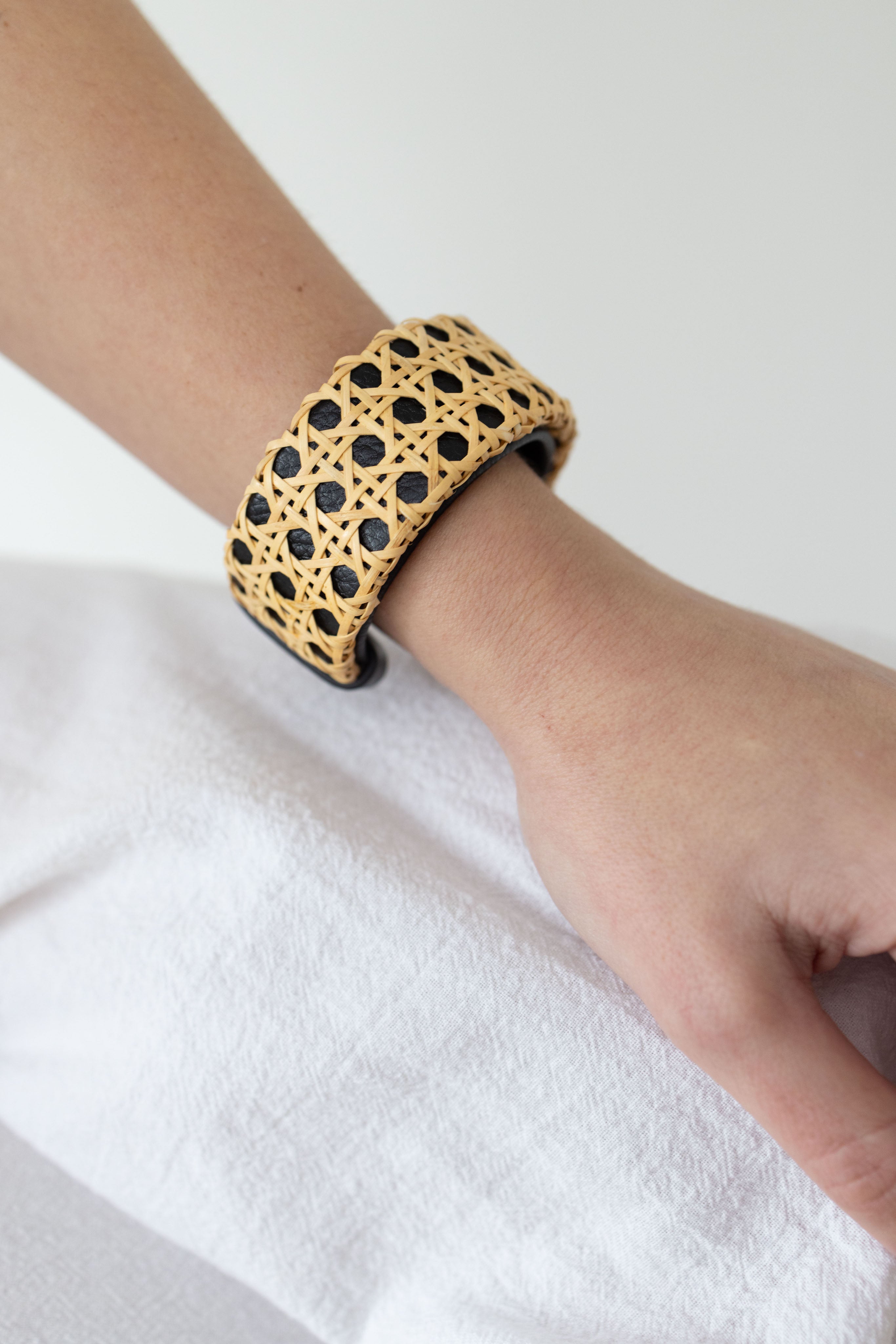 Close up of black cuff around woman's wrist.
