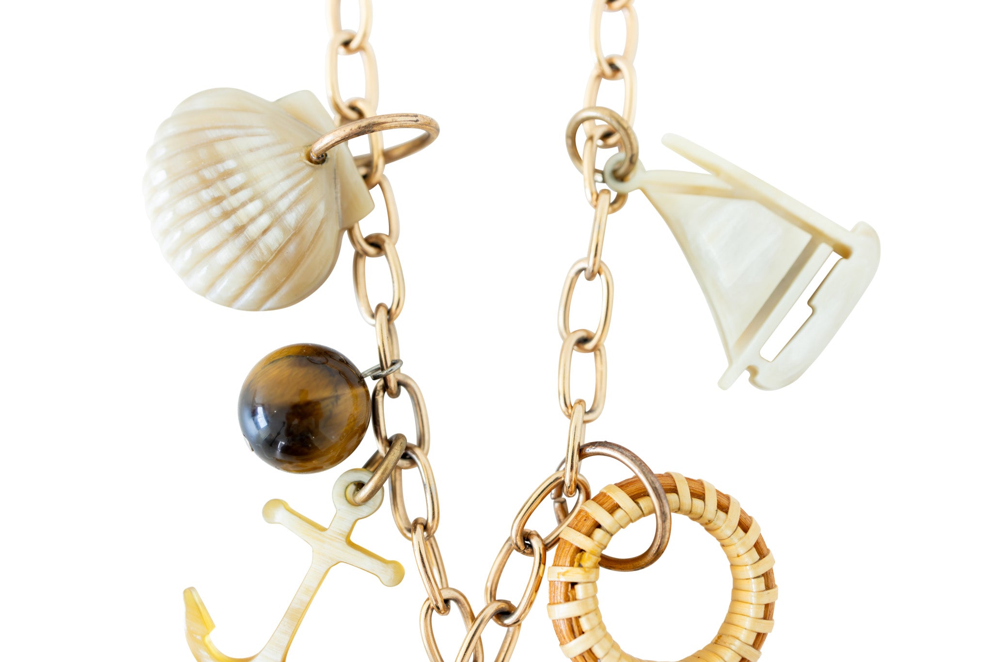 Close up of gold necklace with nautical charms.