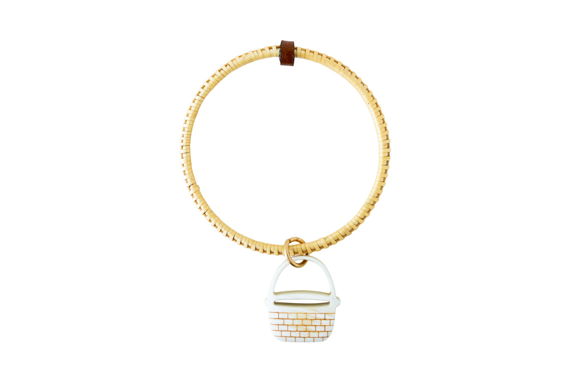 Handwoven bangle with a basket charm.