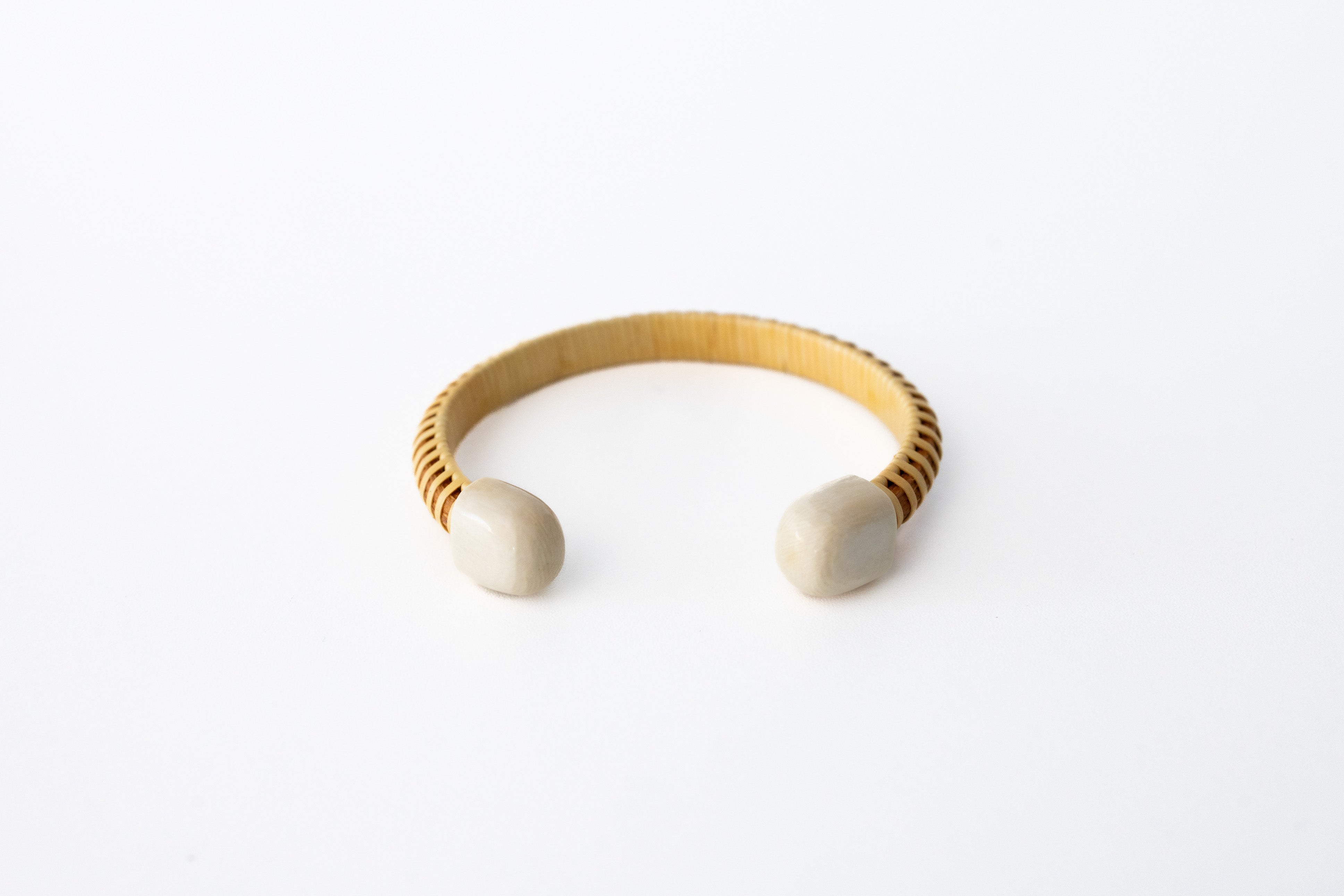 A bracelet cuff with mammoth end caps on a white background.