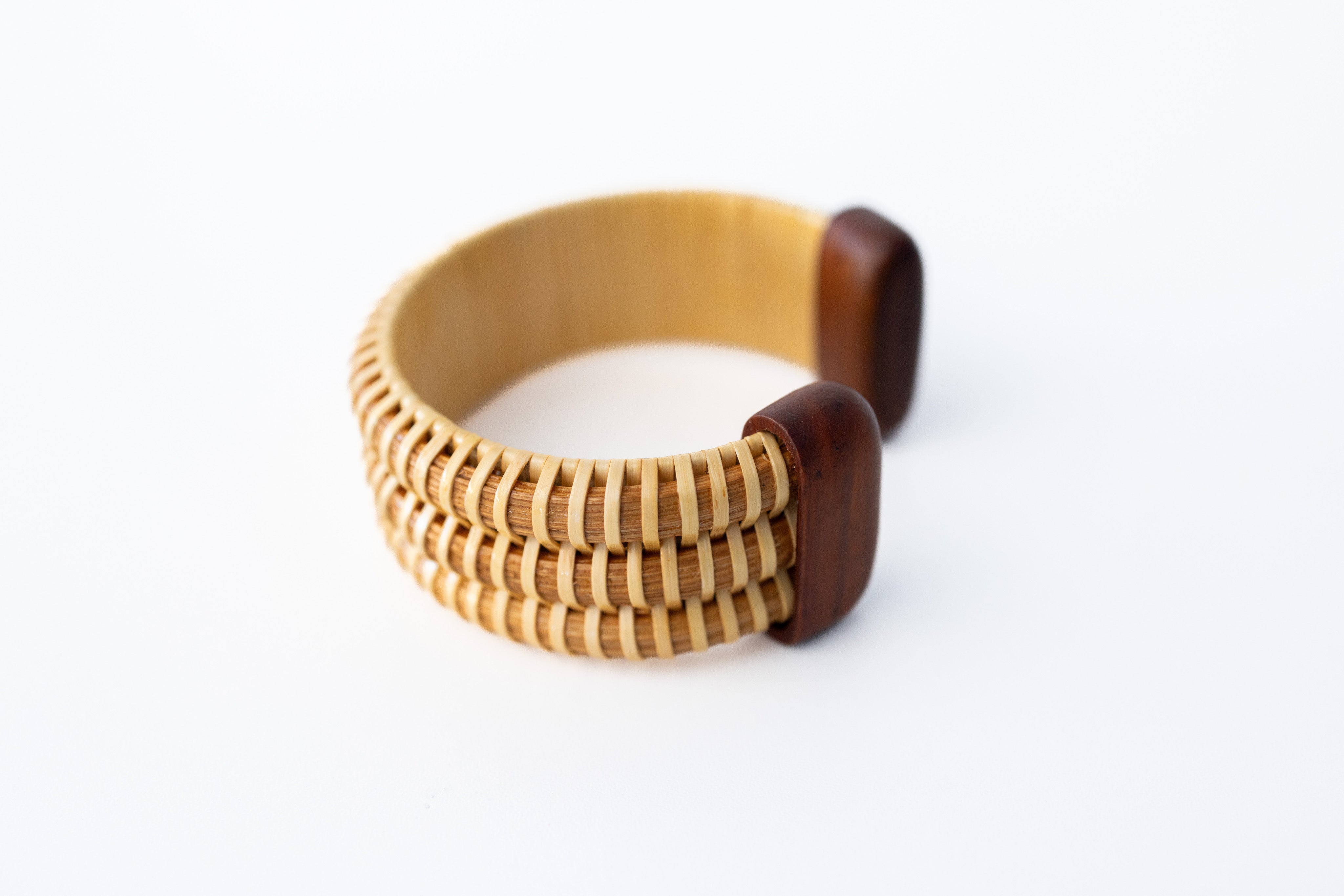 A hand-shaped cherry hardwood cuff bracelet with triple-stave construction.