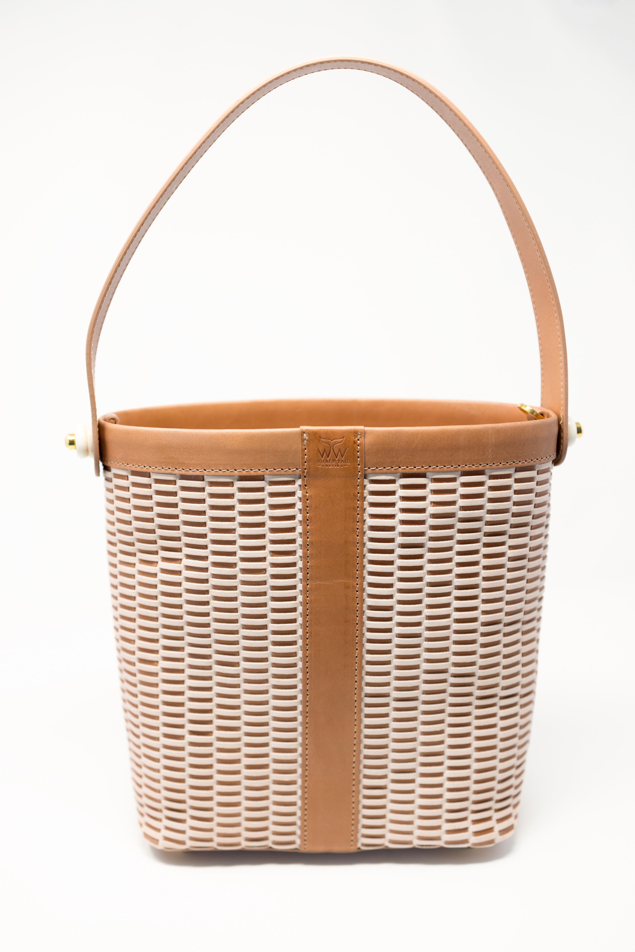 A handwoven Nantucket lightship basket bag, with a textured pattern on the sides, displayed on a white background.