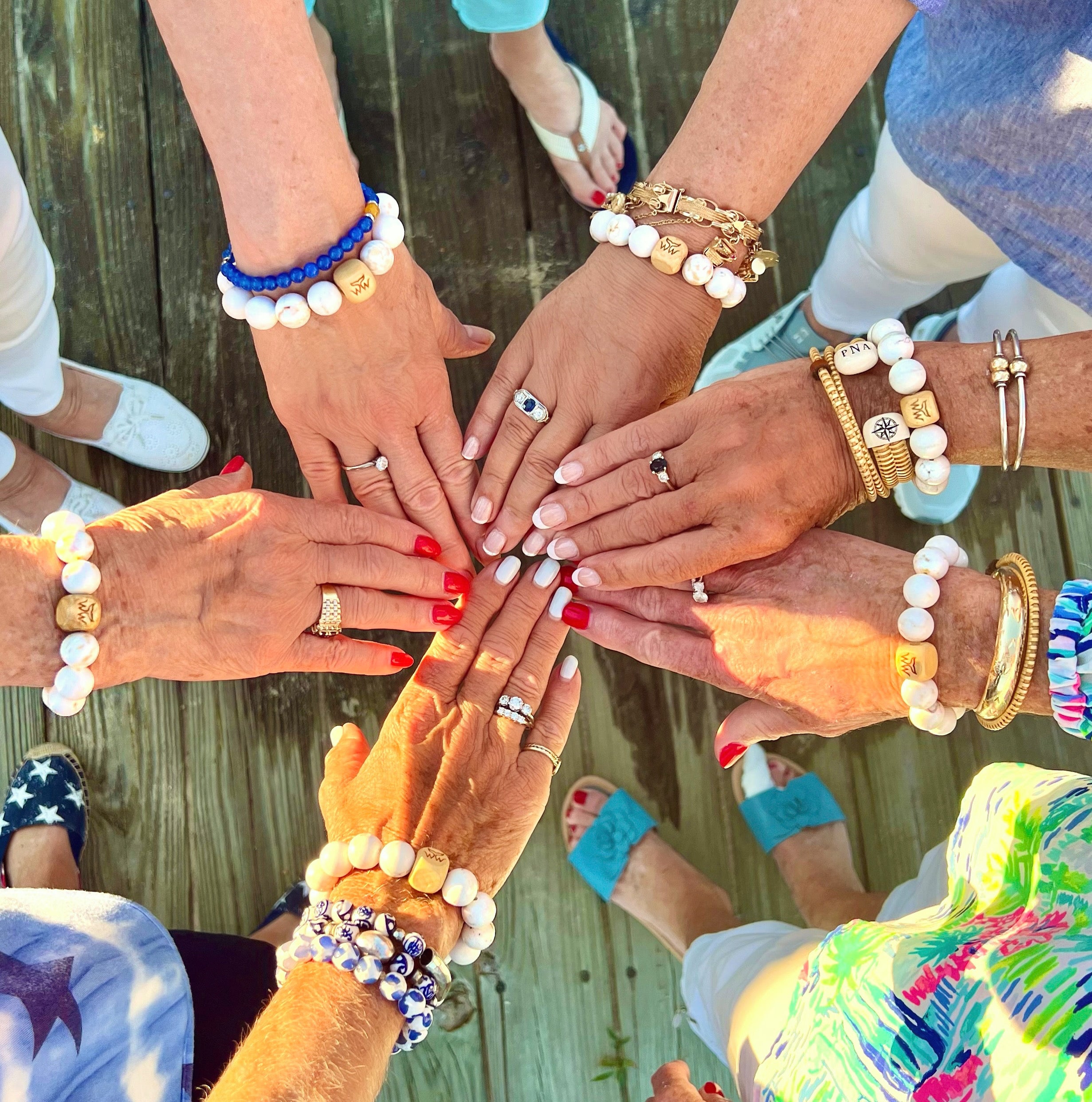 A group photo of hands wearing Nantucket bracelets.