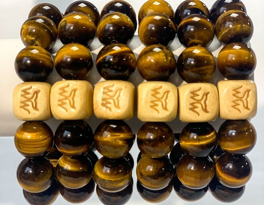 A stack of 6 Dune Bracelets with the WTW logo face up on each.