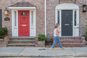 Women walking down the street wearing a Whale Tail Weaving Leather Nantucket Lightship Basket purse.